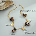 Stainless steel heart pendant necklace with geometric leopard and flower charms on adjustable chain