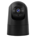 White indoor security camera with wide-angle lens on a table, showing power cable and mounting bracket.