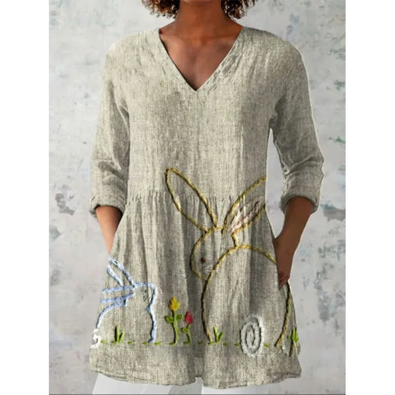 Women's loose-fit printed dress with wide waist and three-quarter length sleeves.