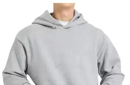 A man wearing a grey fleece-lined cotton pullover hoodie with a wool lining.
