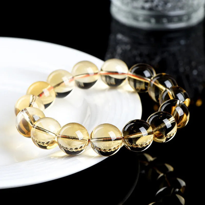 Natural golden citrine bead bracelet with scattered design on a wrist, showing adjustable clasp and polished stone detail.