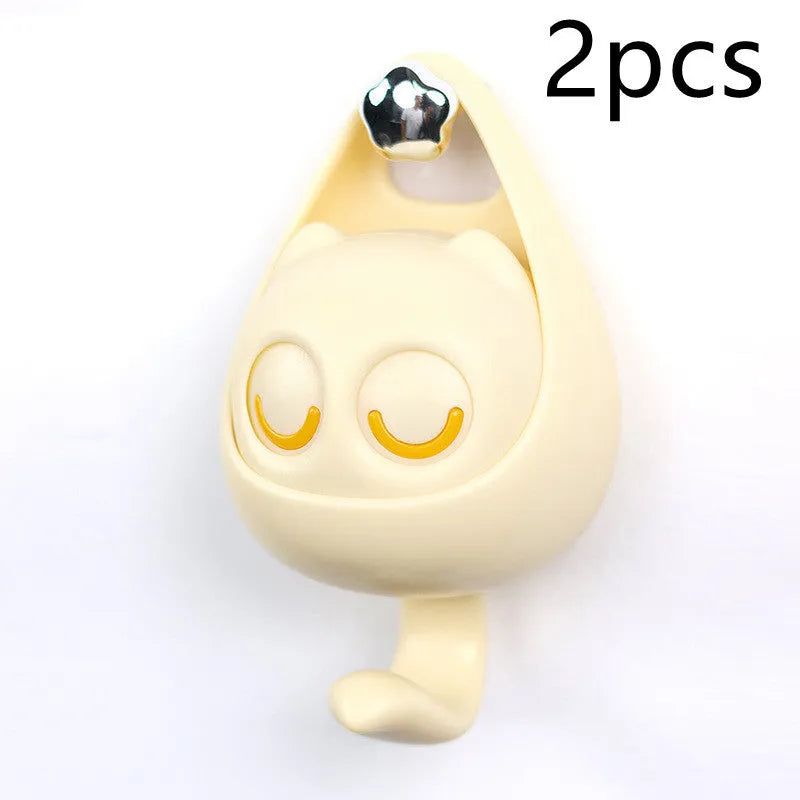Cream white cat-shaped adhesive wall hook with winking eyes, 2.5kg capacity, 105x61x45mm