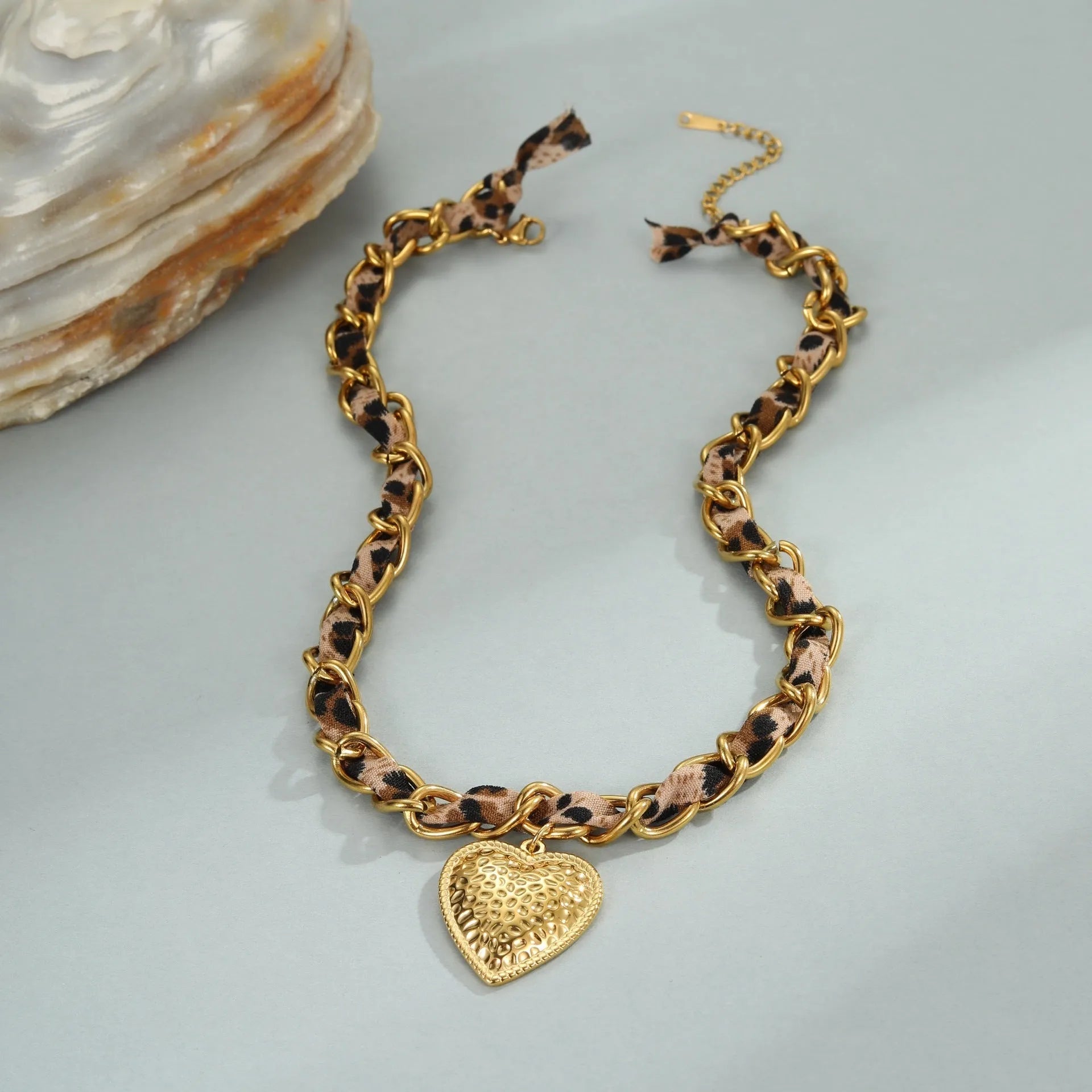 Leopard print geometric heart pendant on a stainless steel chain with adjustable length