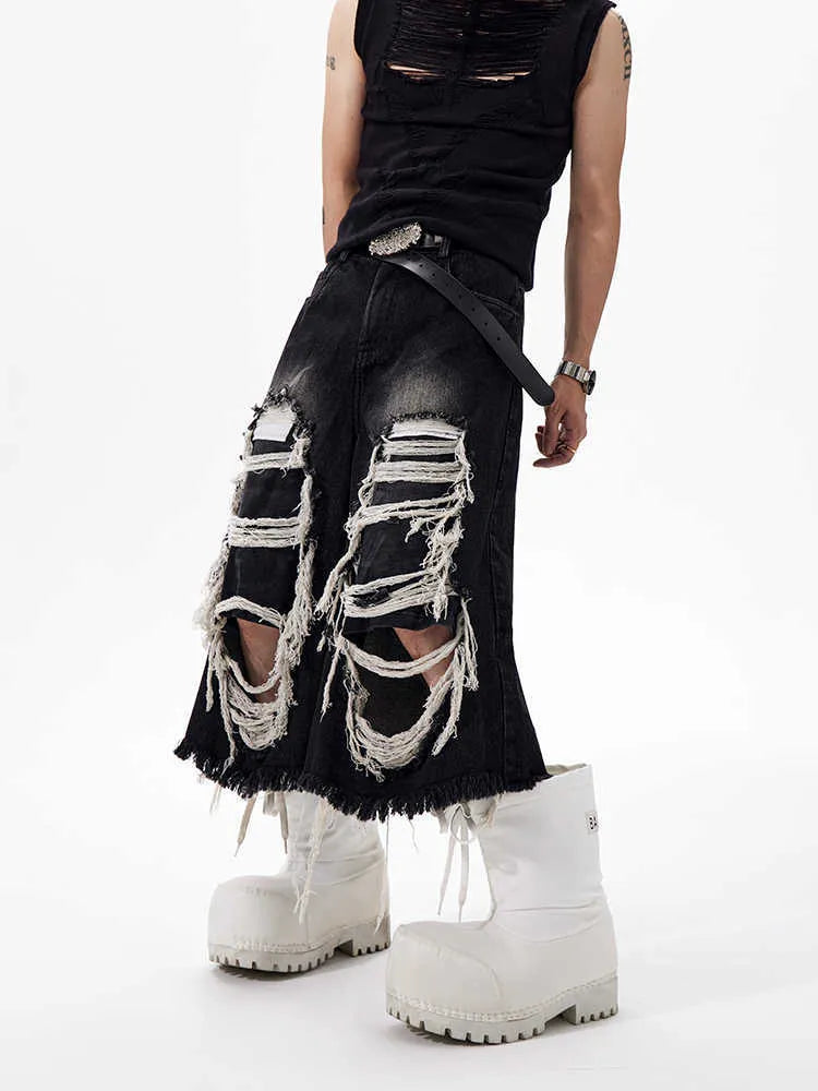 Black cropped wide-leg women's jeans with a ripped patch detail and a mid-high waist.