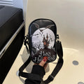 Black Halloween crossbody bag with orange pumpkin, white ghost, and black bat print, showing front zip and adjustable strap.