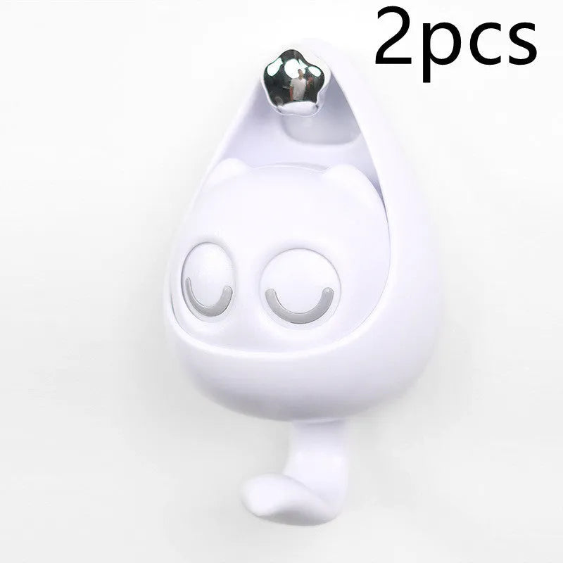 Cream white cat-shaped adhesive wall hook with winking eyes, 2.5kg capacity, 105x61x45mm