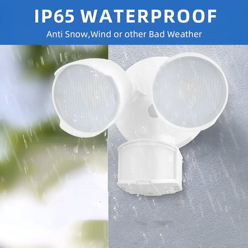 White outdoor LED security flood light with motion sensor mounted on a wall beside a garage door.