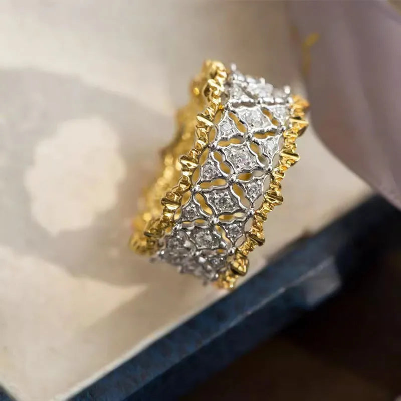Geometric two-tone gold and silver ring with a round zircon on a copper band.