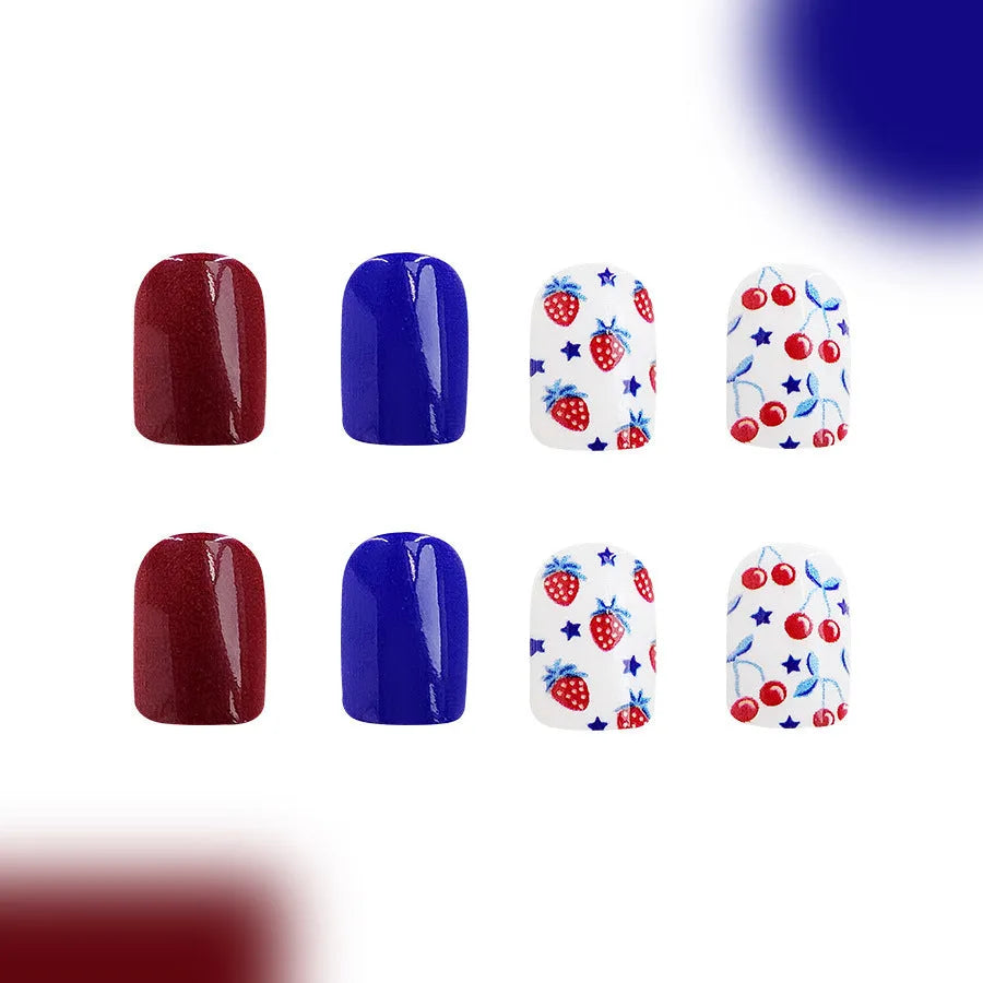 Short glossy false nails with red and blue strawberry cherry pattern, 24 piece set.