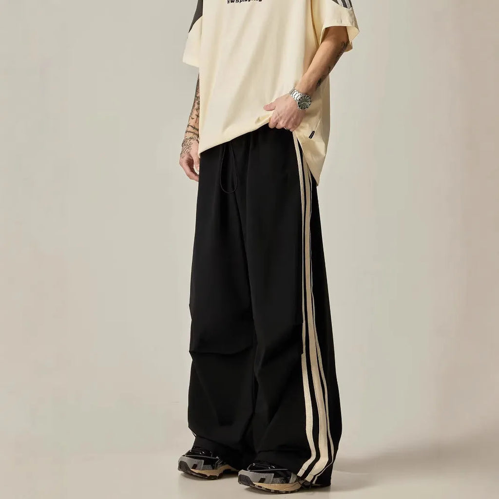 Black high-waist wide-leg climbing trousers for men laid flat, showing straight-leg style.
