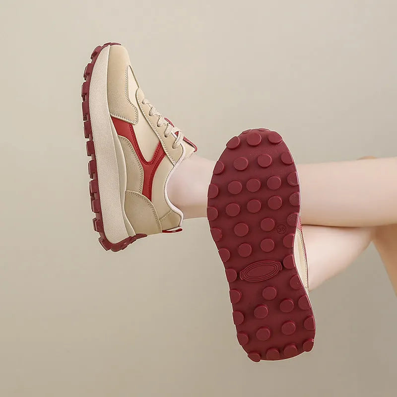 Women's solid colour platform sneakers with lace-up front and flat rubber sole.