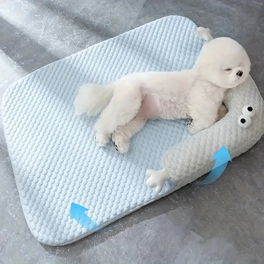 Blue monster design non-slip pet cooling bed for a dog on a hardwood floor.