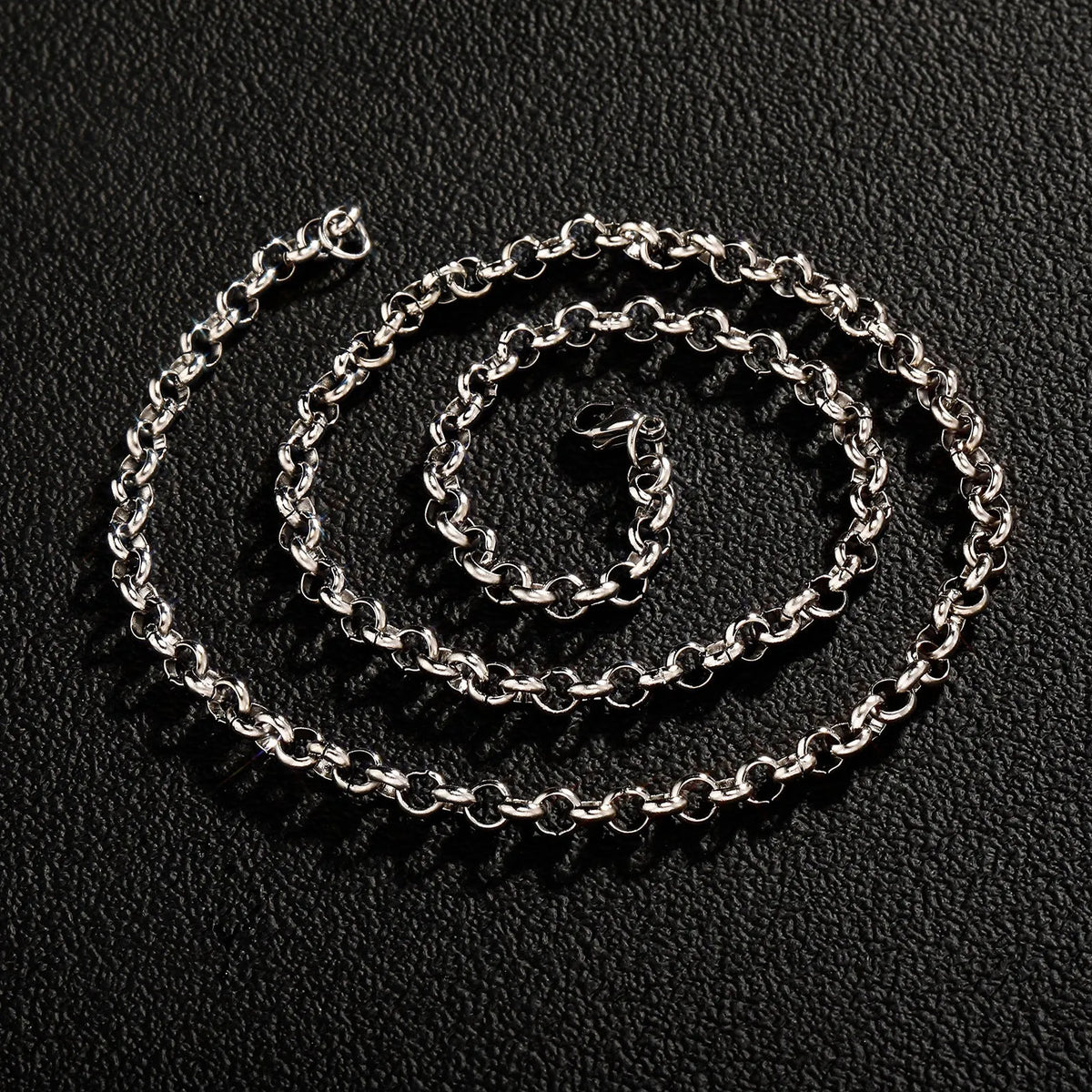 Silver stainless steel men's punk ring buckle necklace with O-ring chain and copper zircon pendant on dark background