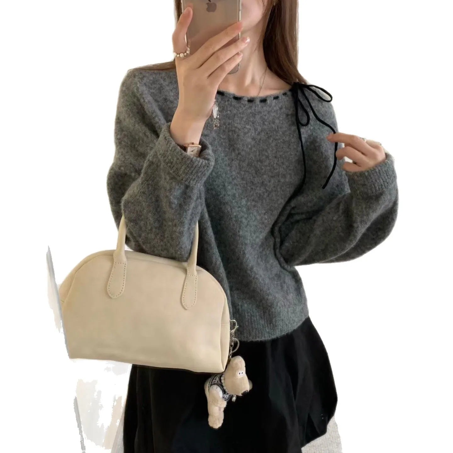 Grey loose-fitting women's pullover knitwear top on a hanger.