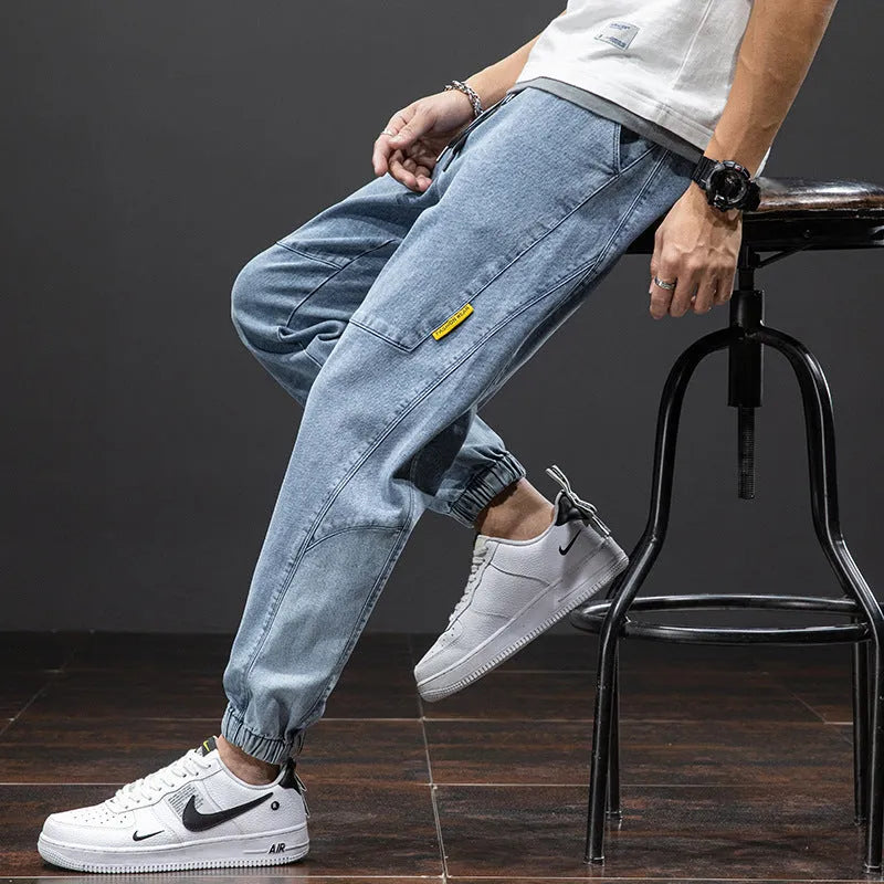 Man wearing loose fit blue cargo jeans with straight leg and cargo pockets