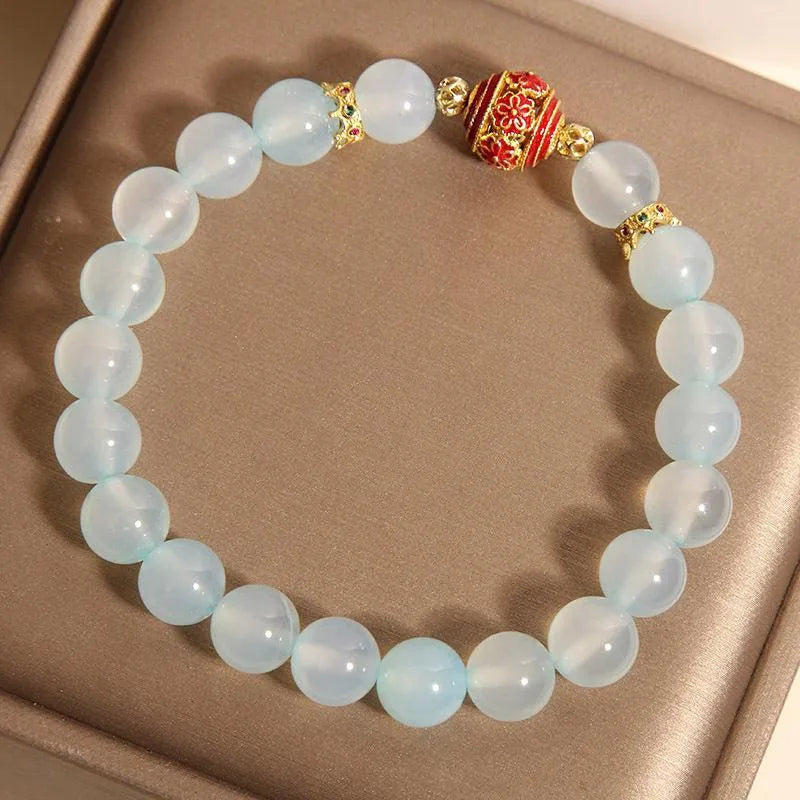 Women's blue agate and crystal bracelet with colourful lucky beads on a wrist.