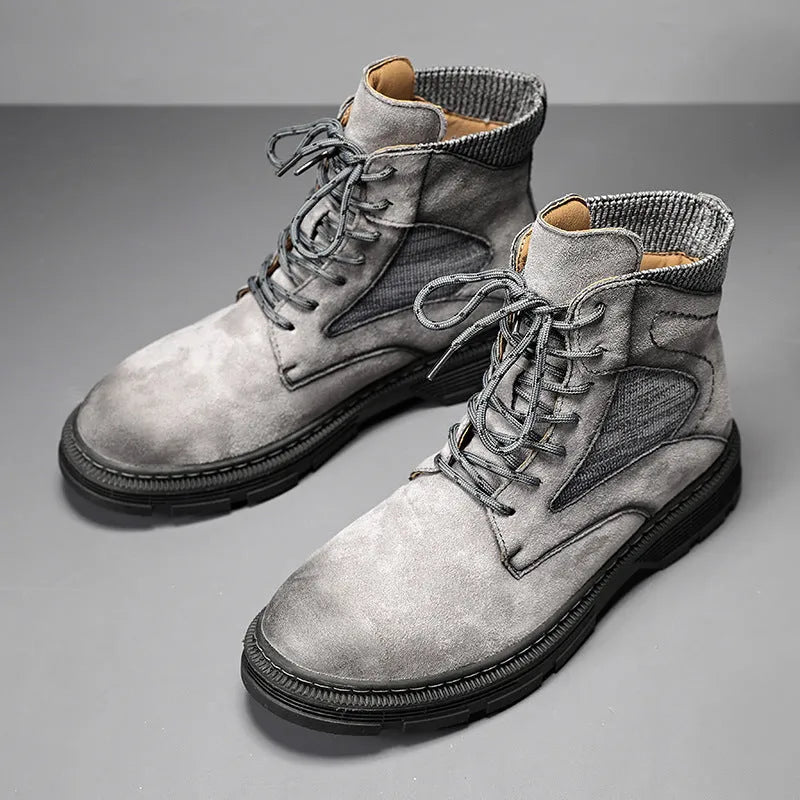 Men's brown frosted leather Martin boots with thick rubber sole on a wooden floor.