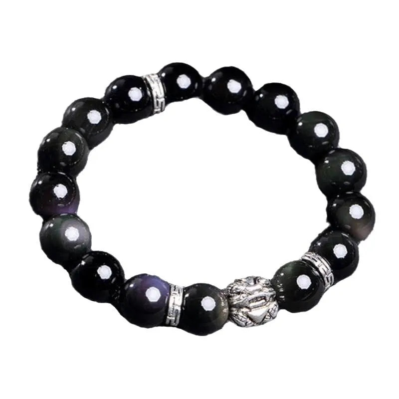 Obsidian unisex bracelet with silver detail in 10mm and 12mm bead size options on a wrist.