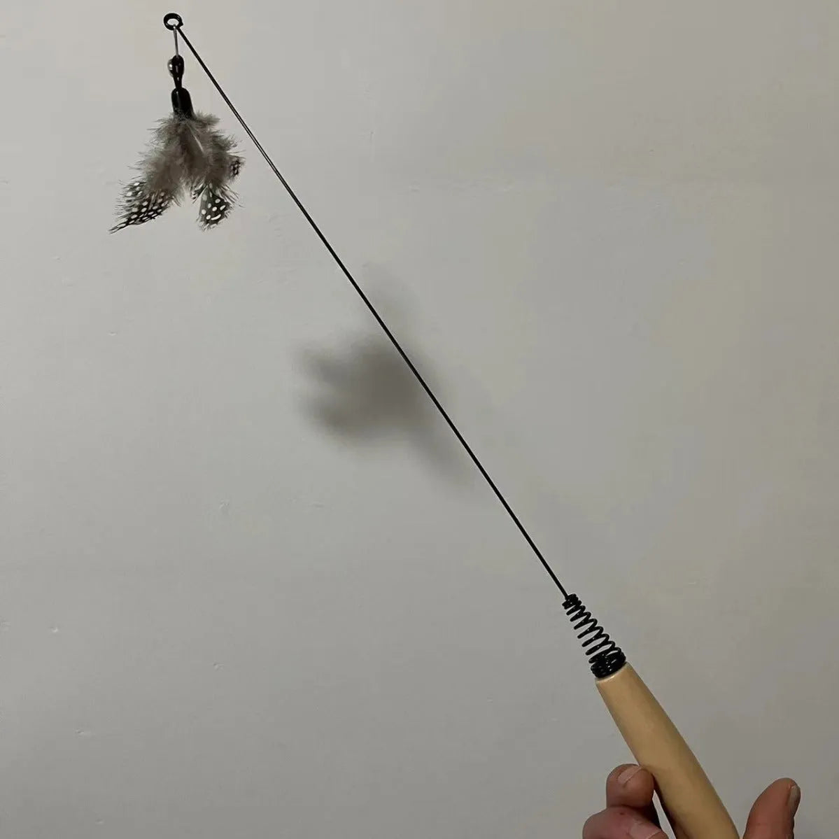 Wooden handle cat teasing stick with feather bell on spring for interactive play