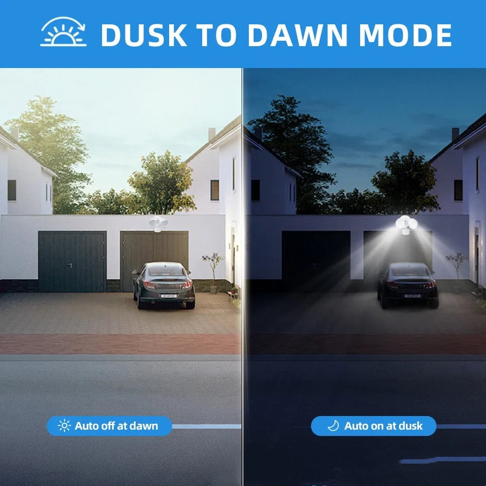 White outdoor LED security flood light with motion sensor mounted on a wall beside a garage door.
