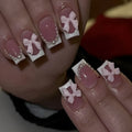 Set of short square press-on nails with white French tips, bow patterns, and tulip designs next to S274 glue bottles.