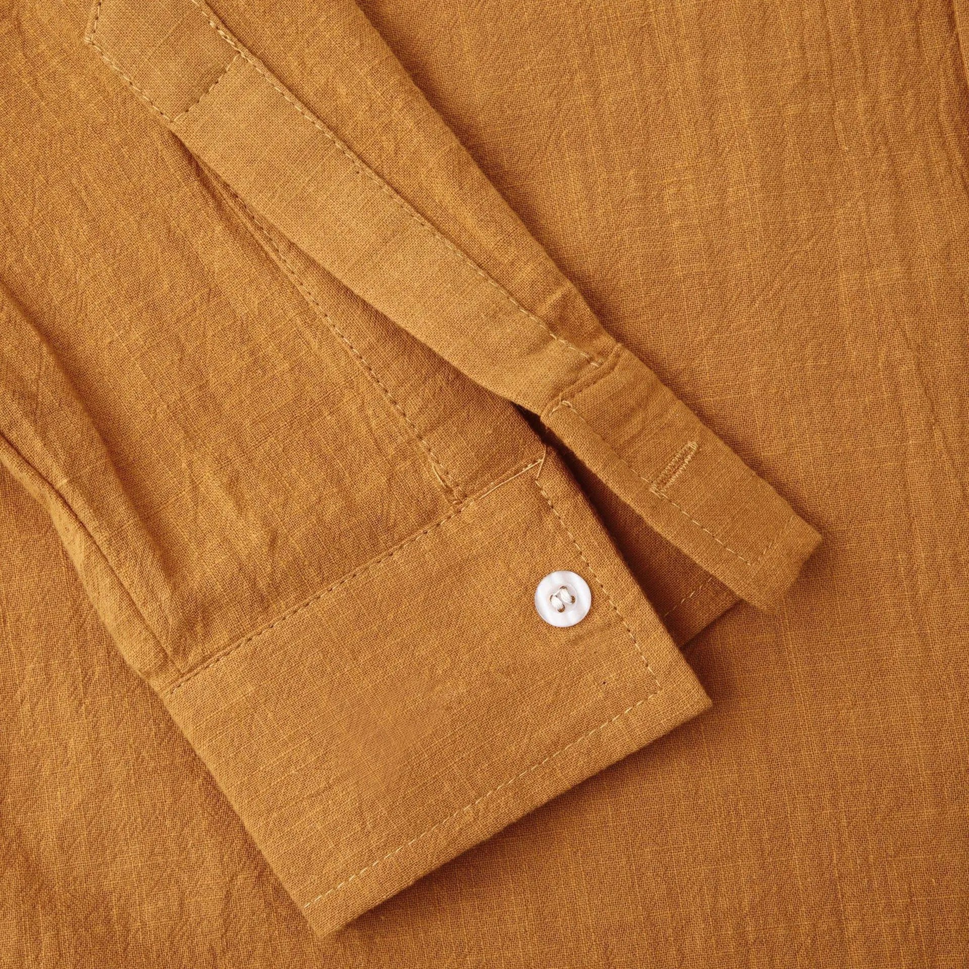 Brown men's slim fit long sleeve shirt and casual trousers on a hanger.