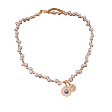 Gold electroplated adjustable clavicle necklace with round zircon and imitation pearl pendant.