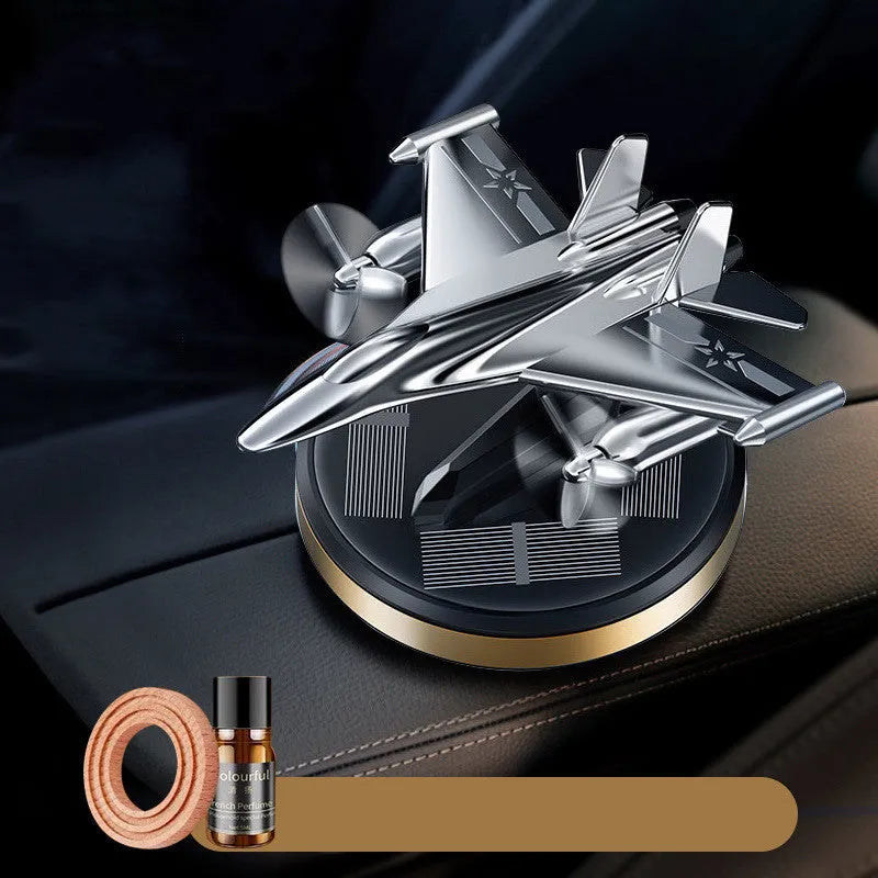 Solar powered rotating fighter aircraft perfume ornament in silver, gold, blue, or red colour.
