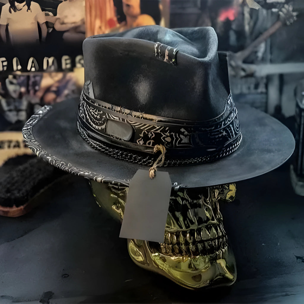 Handmade denim-blue wool felt skull hat with embroidered white skull on front and structured conical crown.