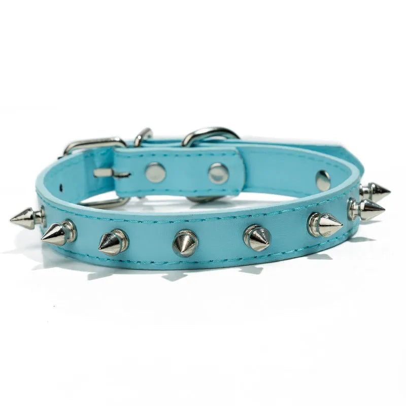 Close-up of a studded black PU leather dog collar with metal spikes and a silver alloy buckle fastener.