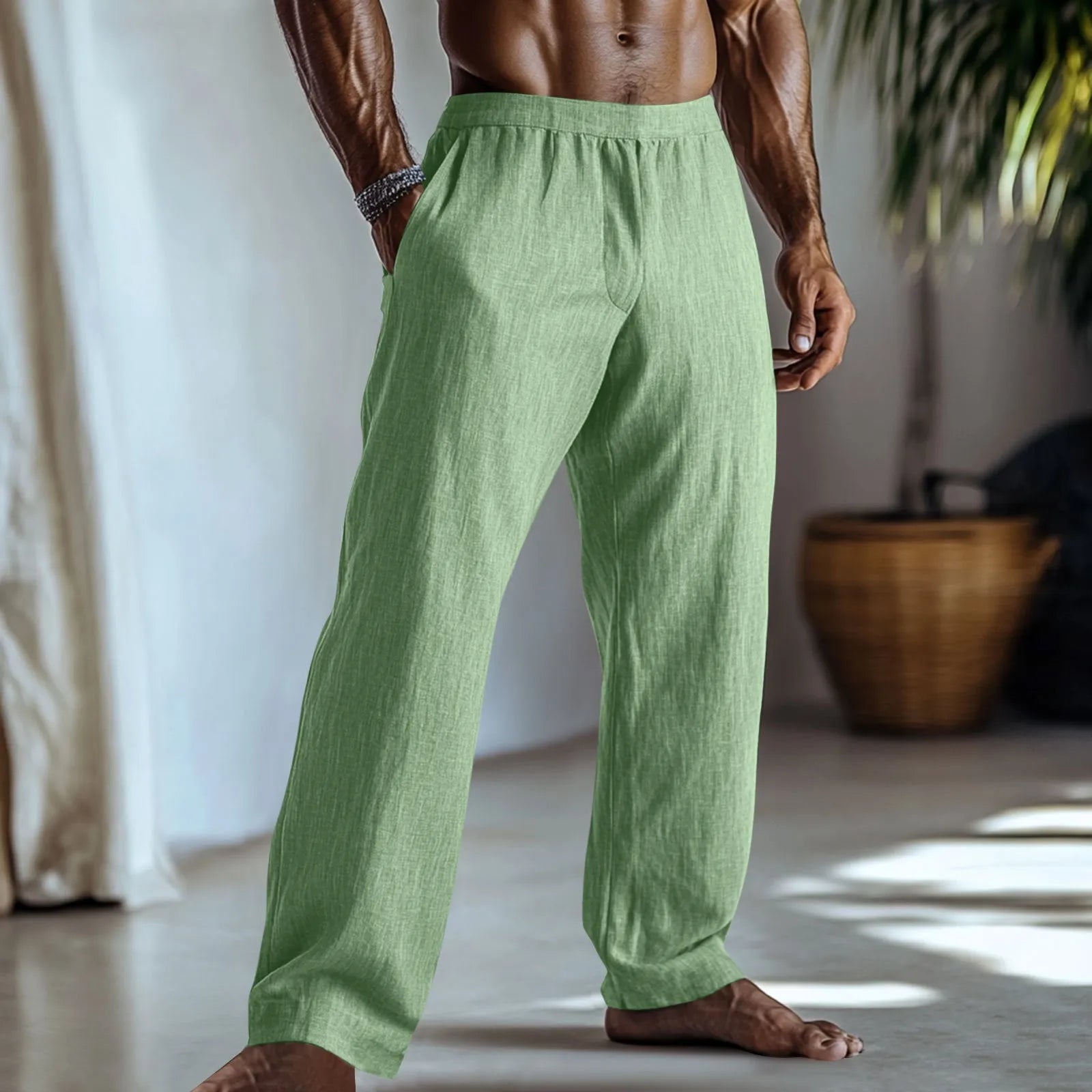 Straight leg cotton linen trousers in light apricot colour on a hanger.