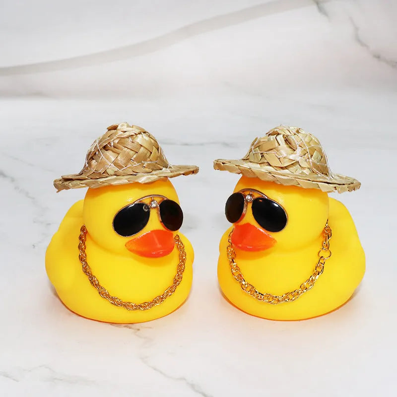 Yellow duck car ornament with straw hat and sunglasses on car dashboard