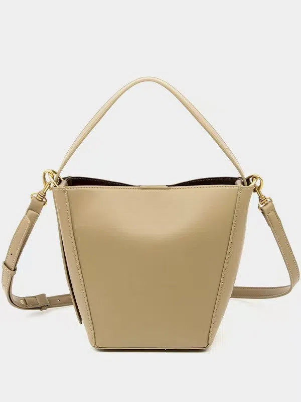 Urban minimalist bucket-style crossbody shoulder bag in PU with three-dimensional outer pocket, black colour option, flat lay view