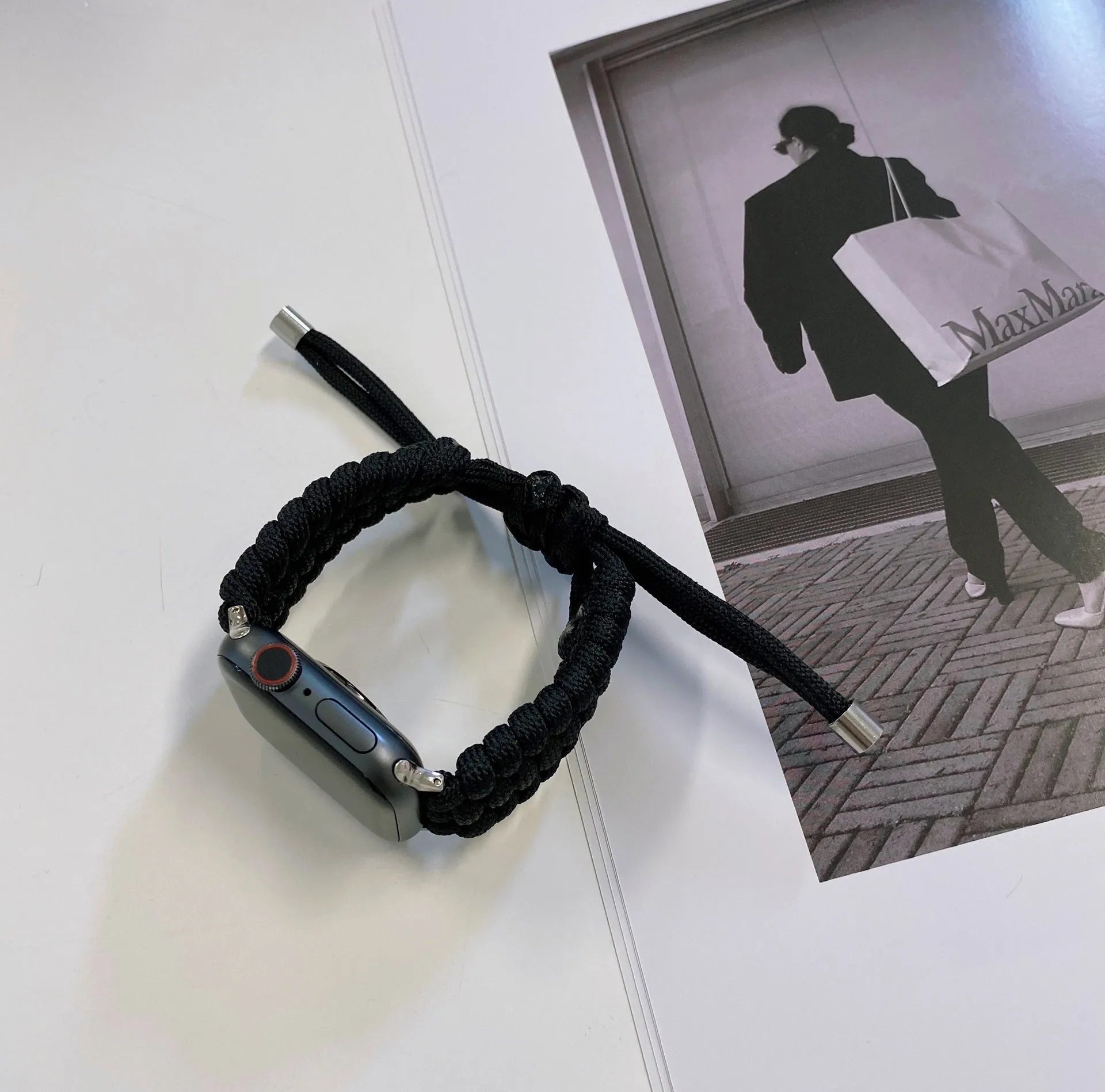 Paracord braided smartwatch strap in black showing textured weave and standard spring bar lugs.