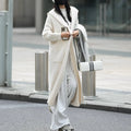Long grey knitted cardigan with a hood and trench coat style, shown unbuttoned.