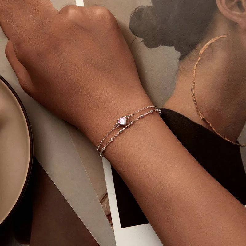 Women's sweet style sterling silver bracelet with small heart pendant on an adjustable chain.