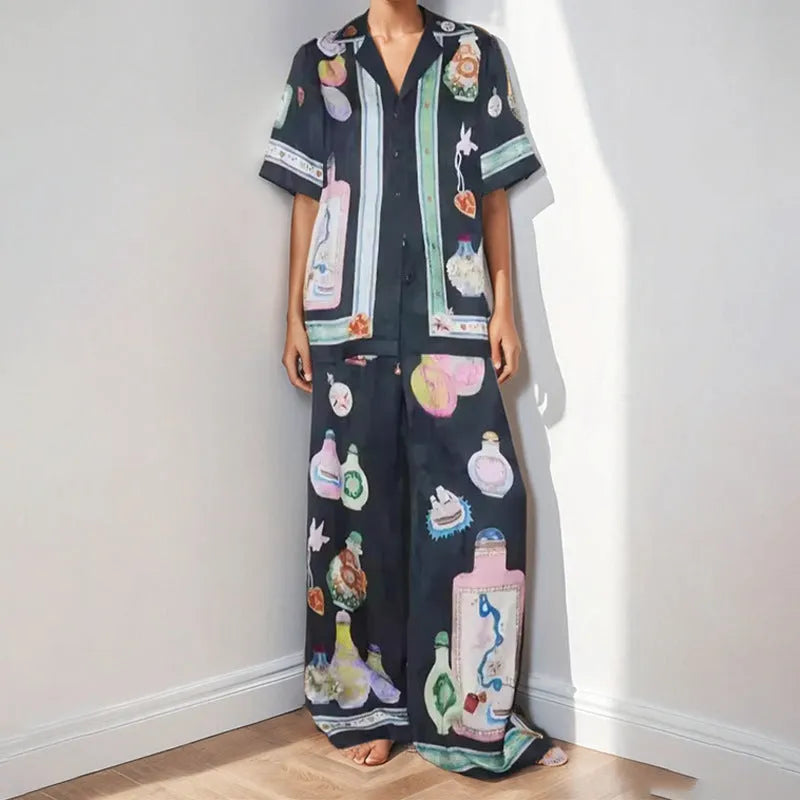 Black women's casual set with cartoon print, featuring a cardigan and trousers.