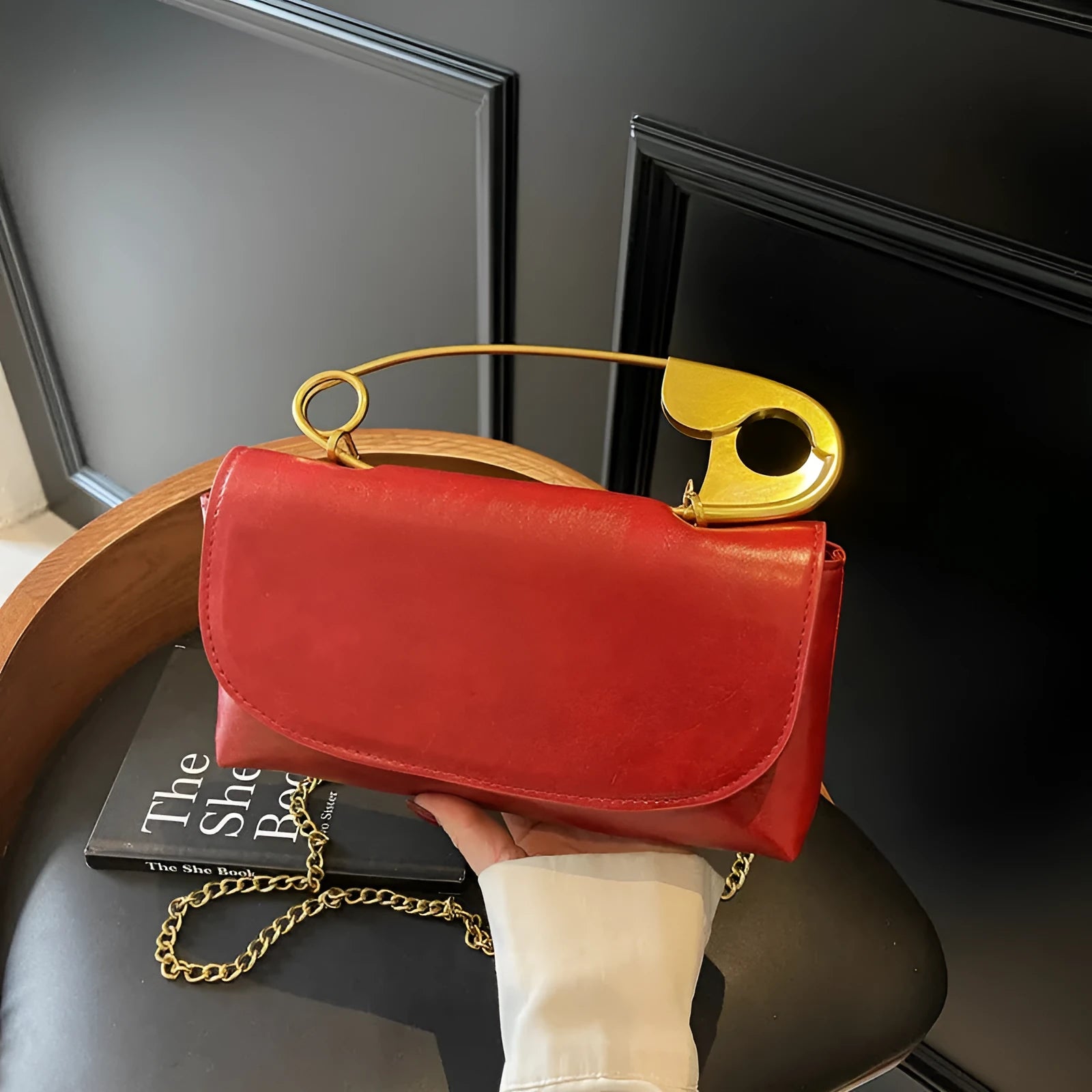 Creative personality paper clip shoulder handbag in PU leather with sandwich pocket and file bag interior.