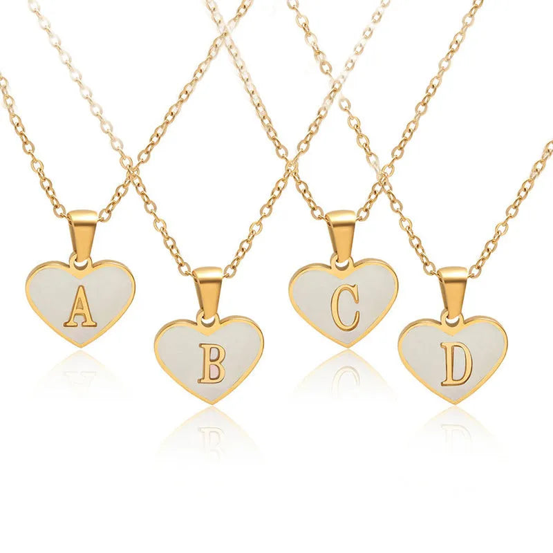 Gold plated heart-shaped white shell necklace with personalised text on a stainless steel chain.