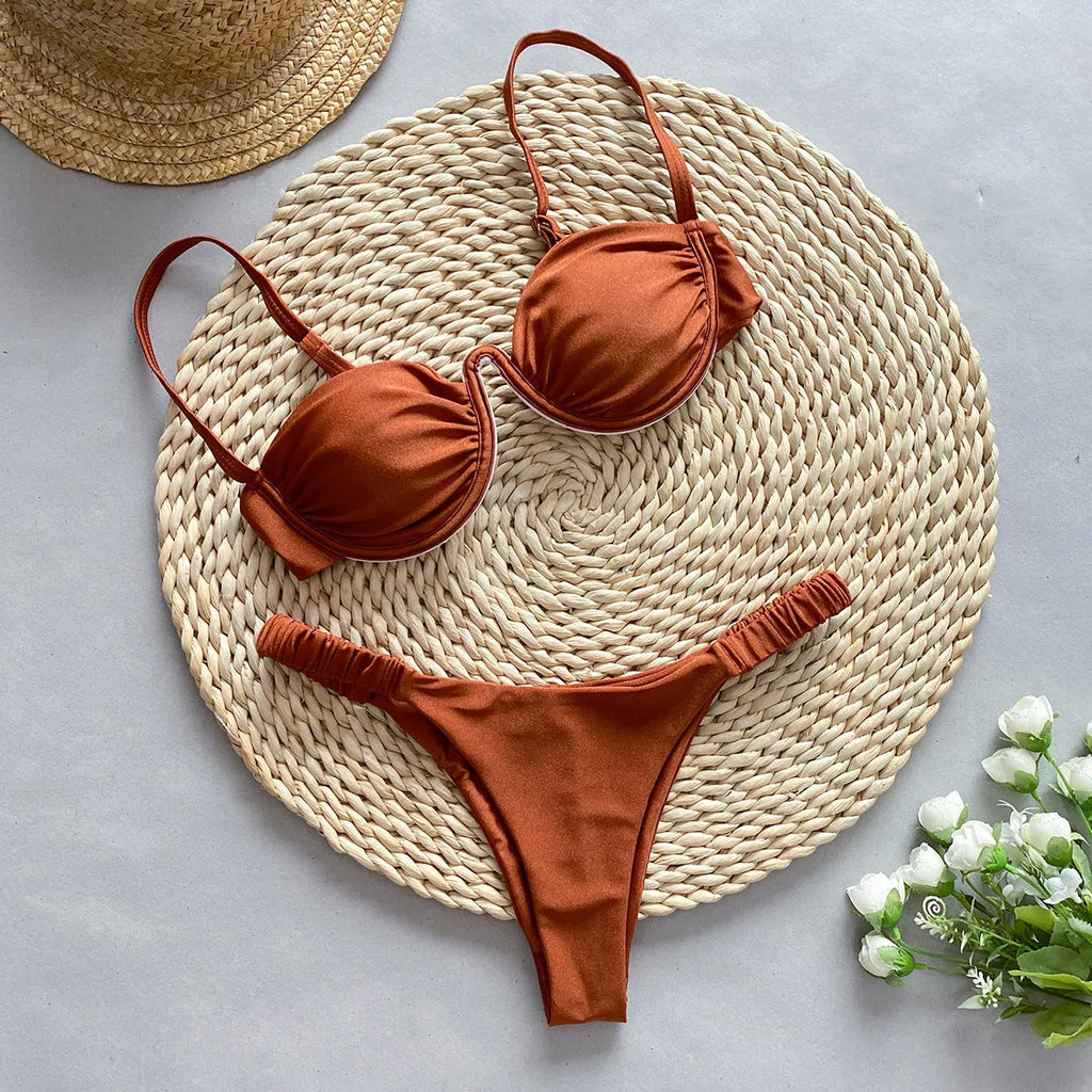 Women's black underwire bikini swimsuit on a mannequin, showing briefs style.