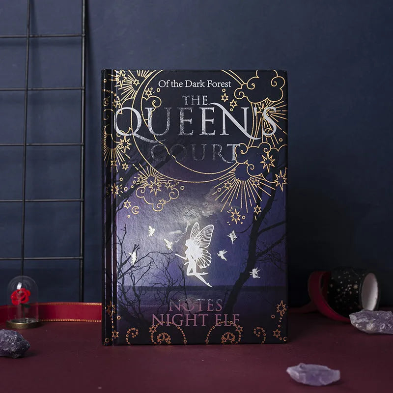 Blue luminous A5 hardcover notebook with night elves illustration and open full-colour pages.