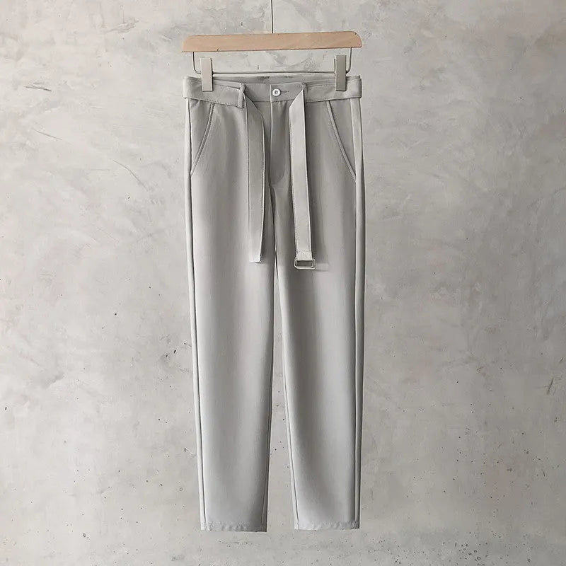 Boy wearing slim straight grey wool blend trousers in a business casual style.