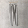 Boy wearing slim straight grey wool blend trousers in a business casual style.