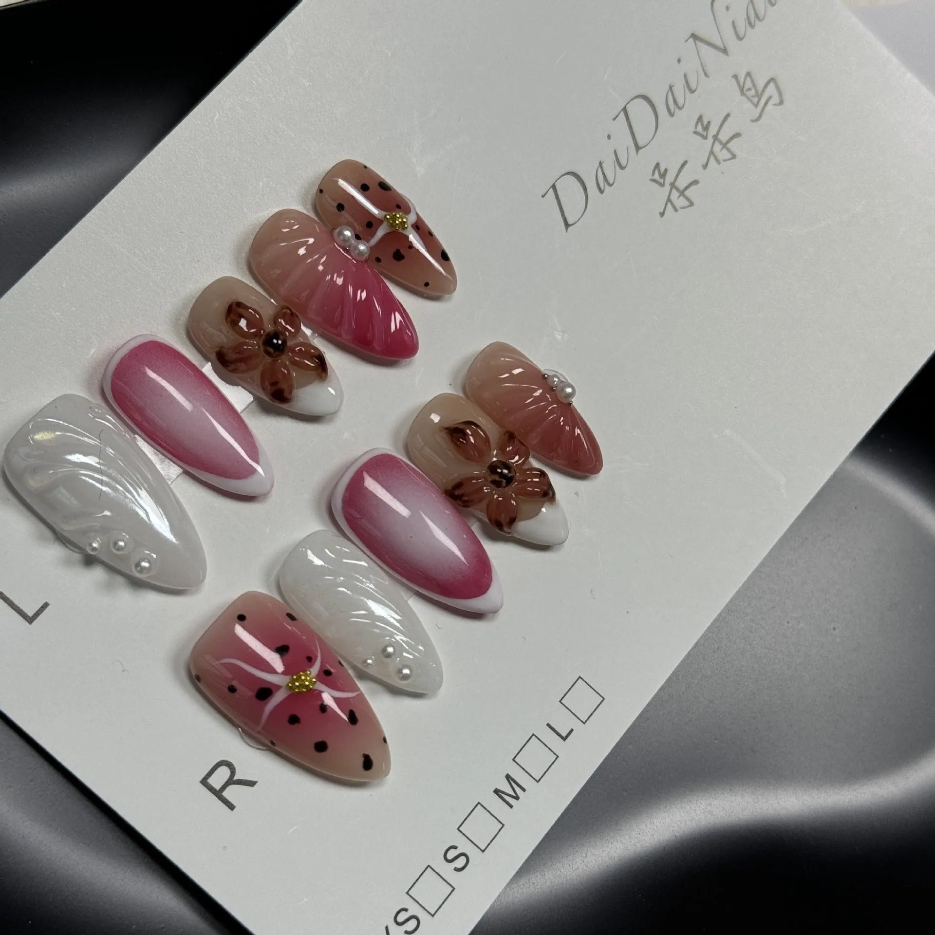 Hand-painted three-dimensional false nails with embossed carved patterns in candy colours.