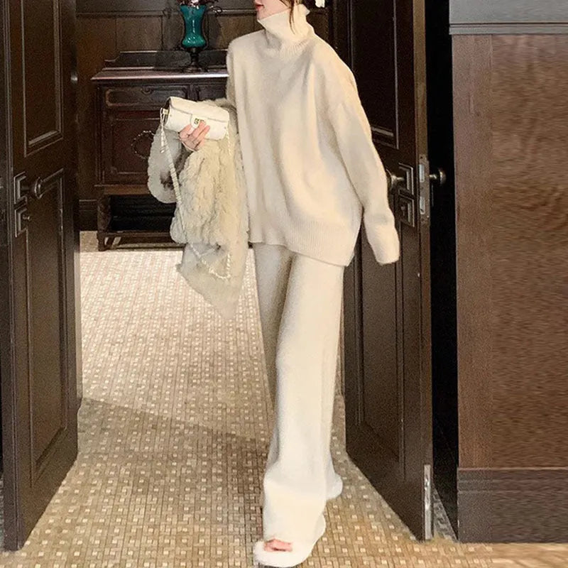 Women's beige acrylic knit sweater and wide-leg trousers two-piece set laid flat.