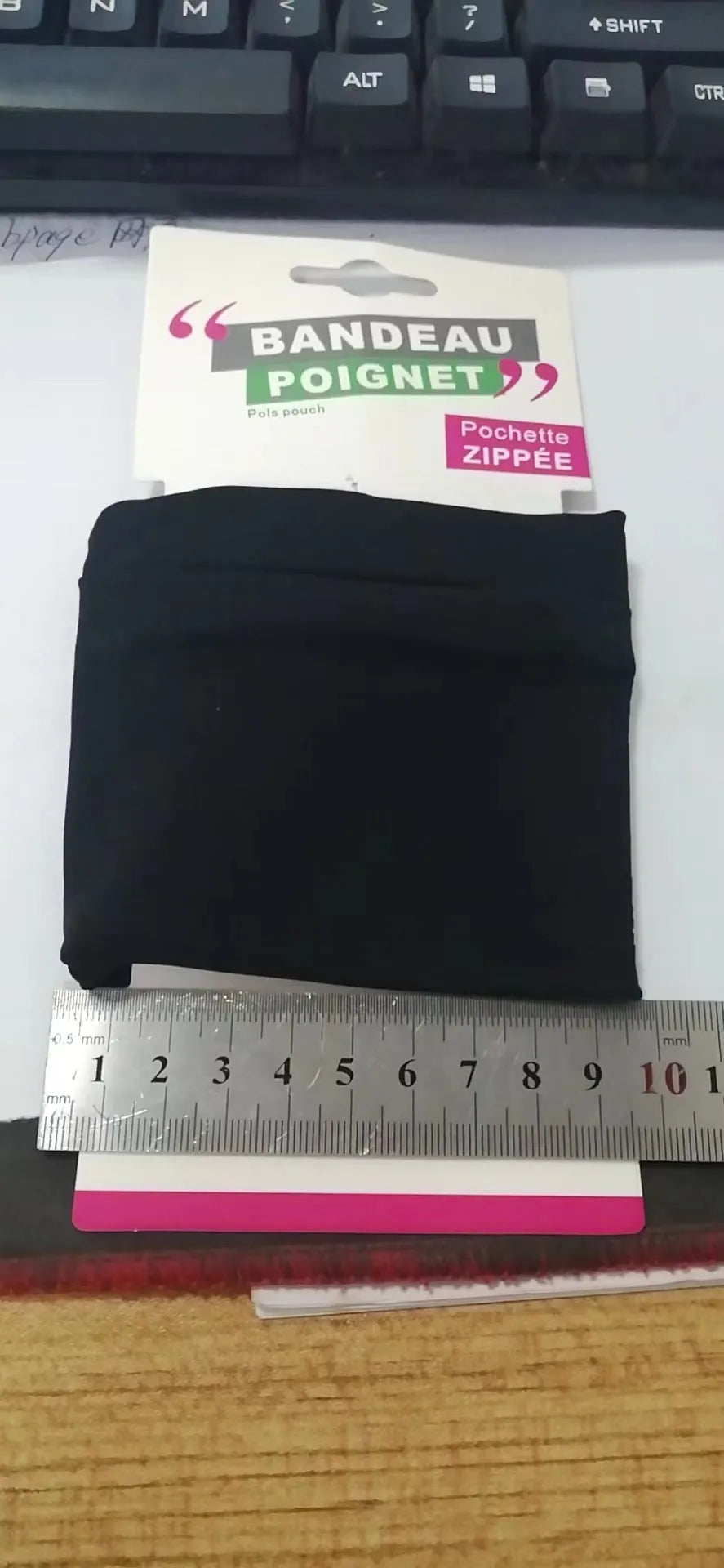 Black wrist bag armband sleeve with strap, showing 10cm by 10.5cm front pocket for a mobile phone.