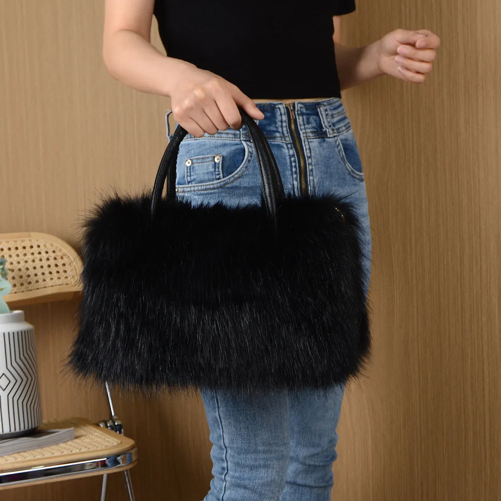 Hand-carrying square plush bag in pink with soft faux fur exterior and horizontal shape