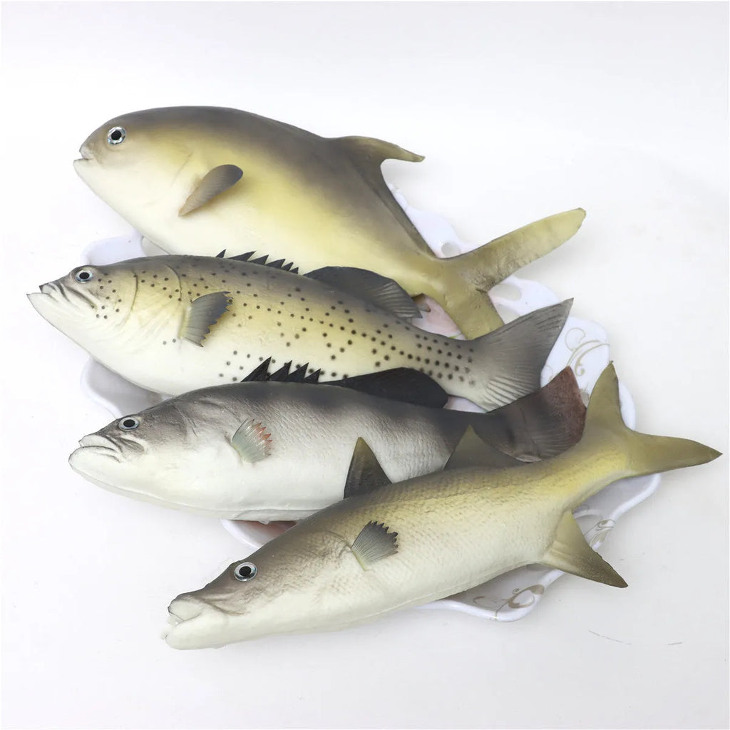 Set of four colourful PU simulated fish model ornaments including tuna and flower fish on a white background.