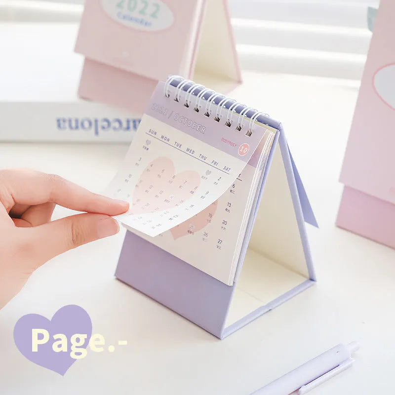 Cream coil-bound desk calendar for 2022, paper, 210g, Regular size 100x100x172mm, on a desk