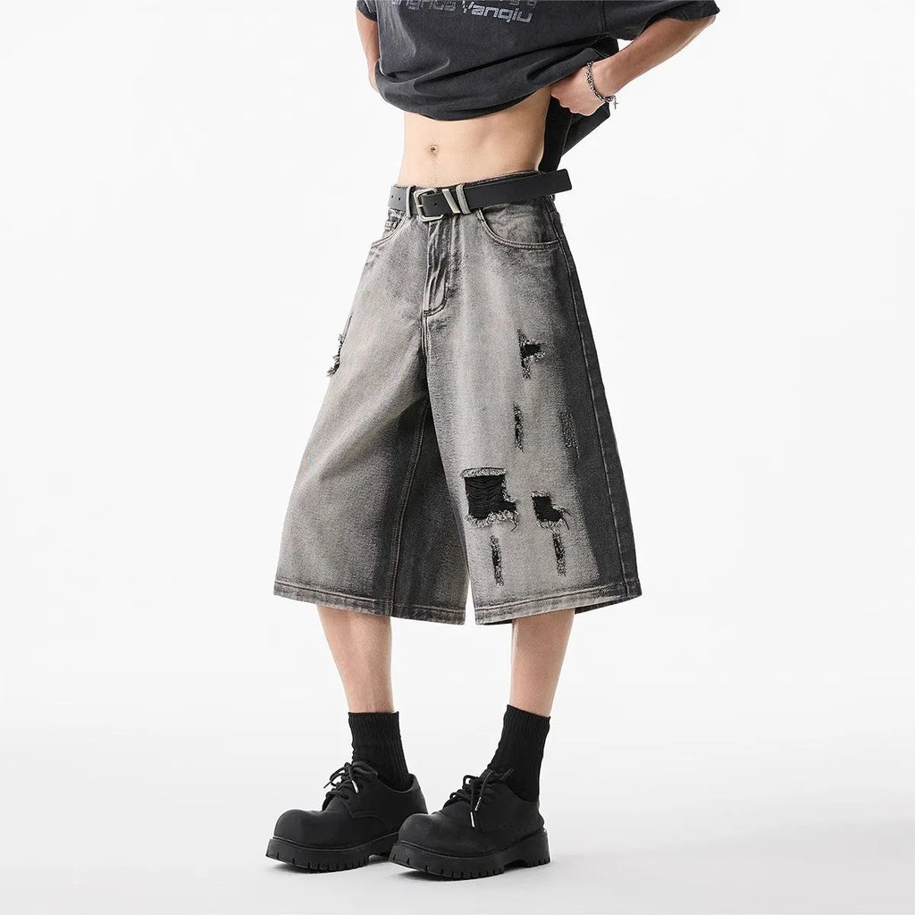 Grey water washed denim shorts with hole detailing and loose retro fit